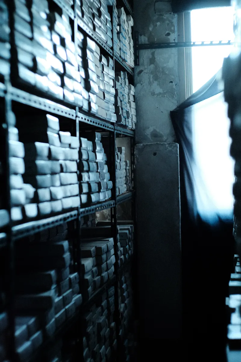 Shelves of boxed goods in a narrow shop
