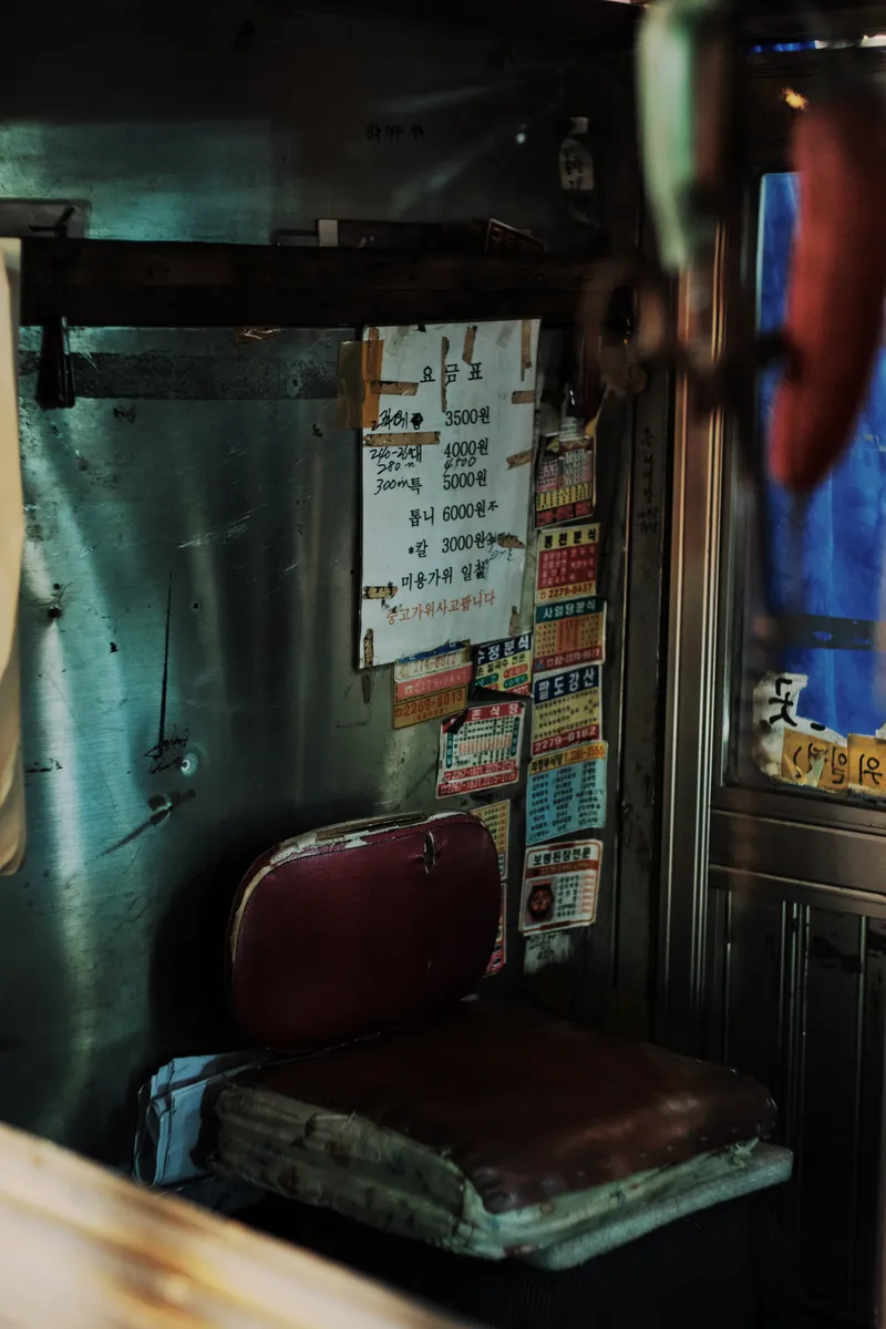 Corner with a red cushioned chair and notices on the wall