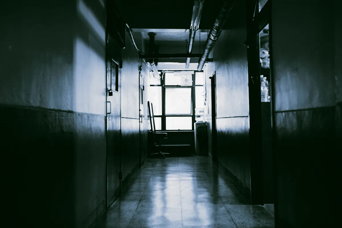 Dark corridor with a window at the far end