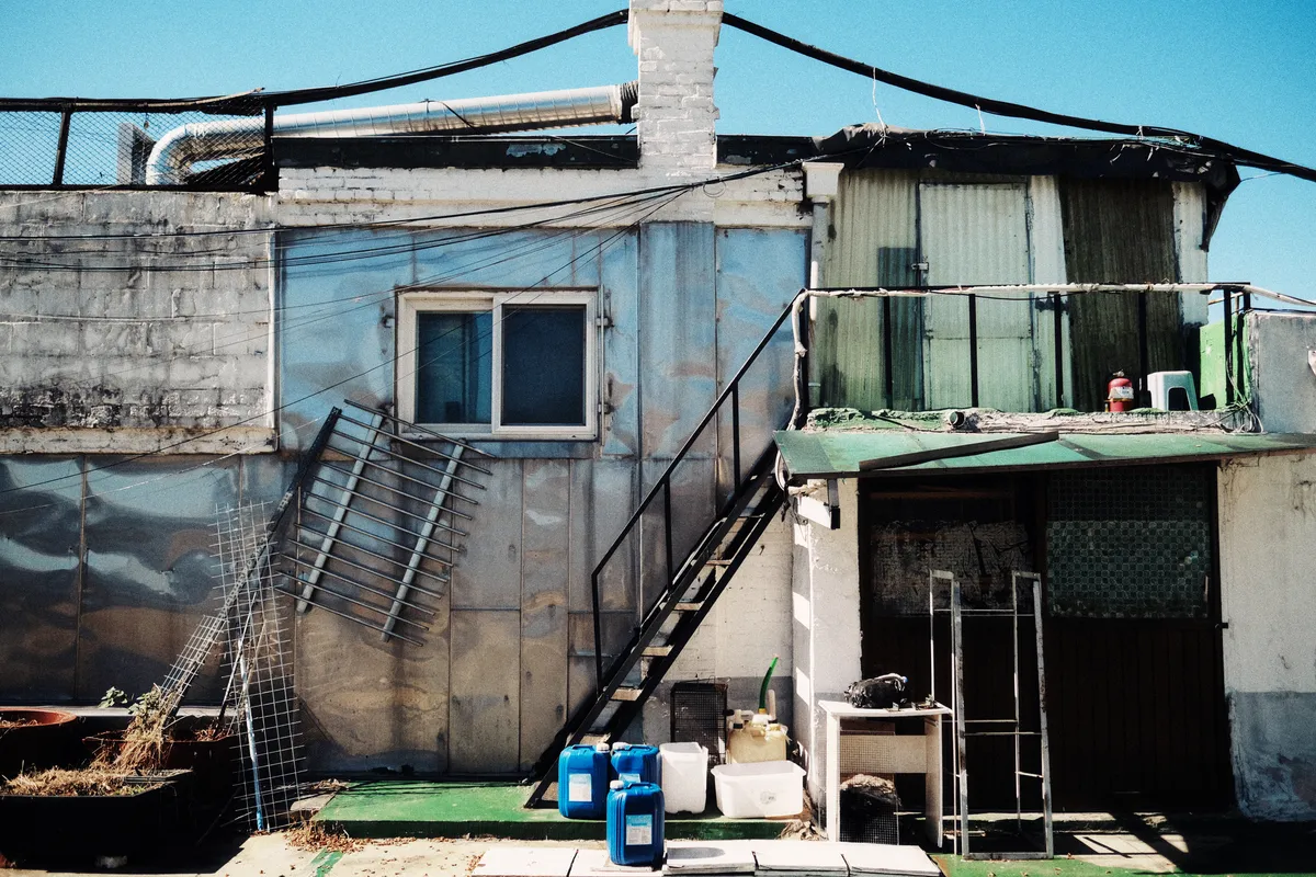 Low building with an outside staircase under a blue sky