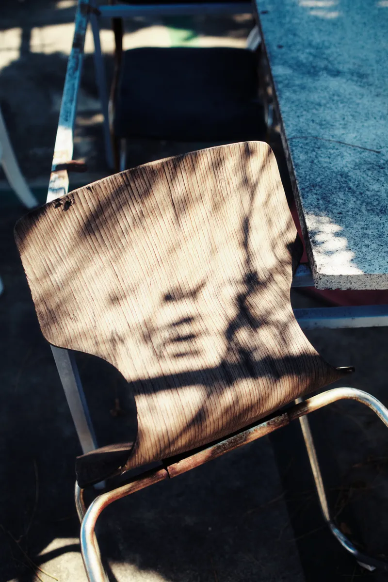 Wooden chair with a metal frame in sunlight and shadow