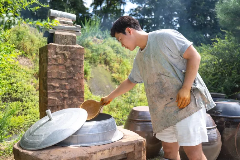 Ladling lye water from the cauldron